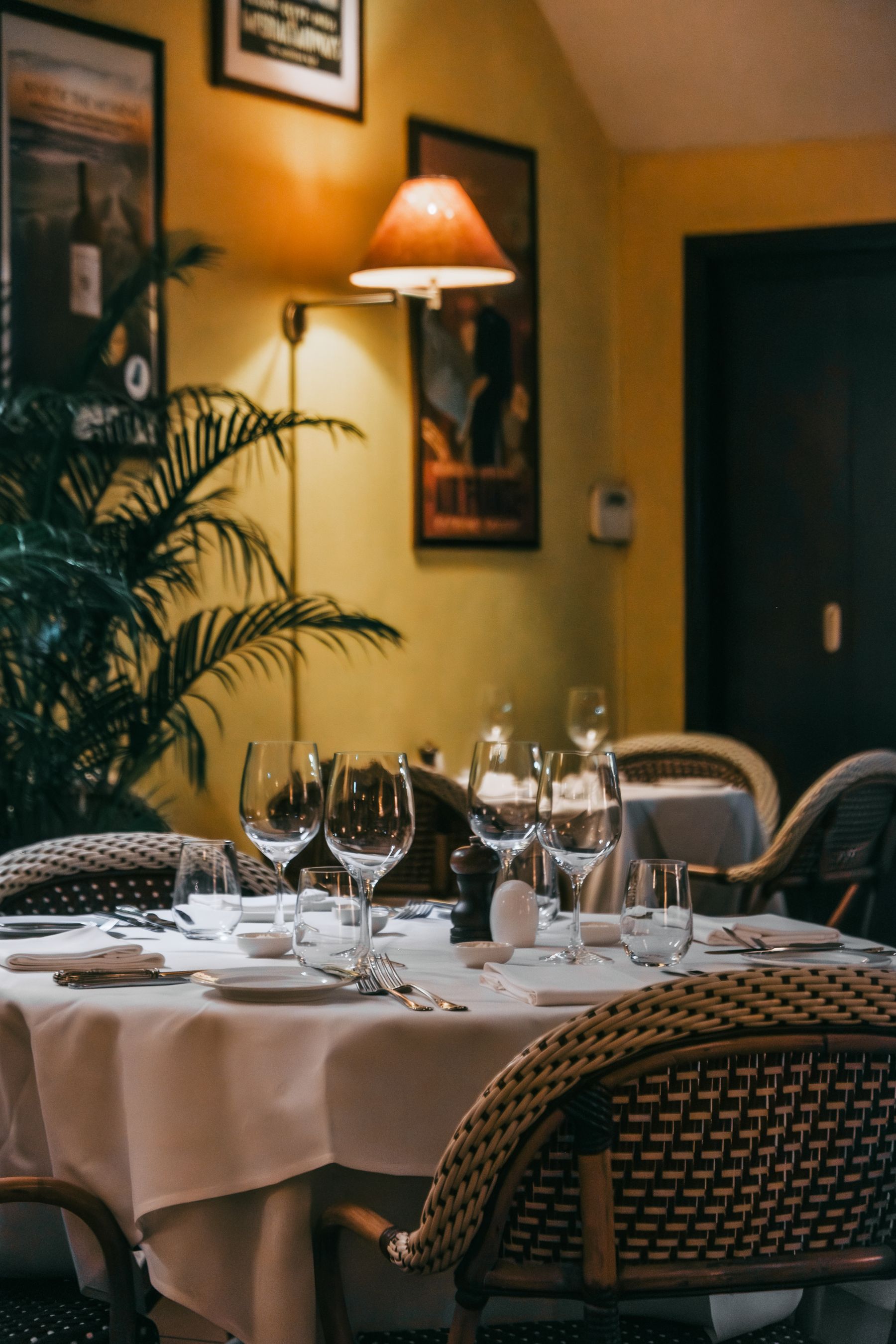 Warmly lit restaurant dining room with set tables